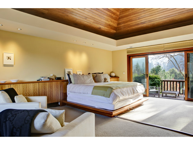 140 Farm Road Woodside, CA 94062 - Photo 12 of 16 a bedroom with a bed and glass window