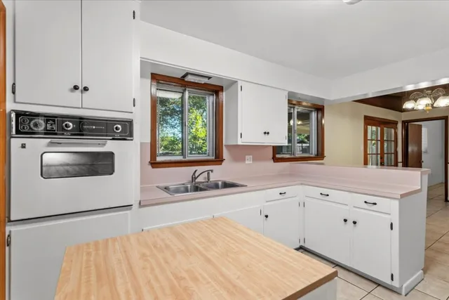 a kitchen with a sink stove and cabinets