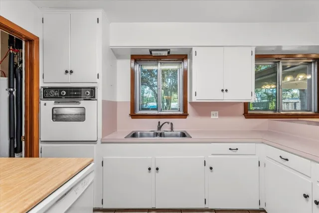 a kitchen with a sink a refrigerator and window