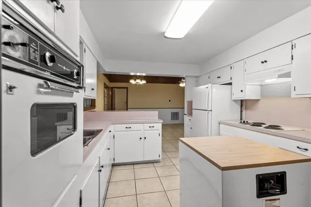 a kitchen with a stove a refrigerator and a sink