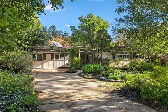 a front view of a house with a garden