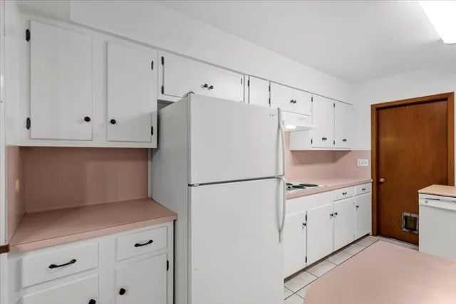 a white refrigerator freezer sitting inside of a kitchen