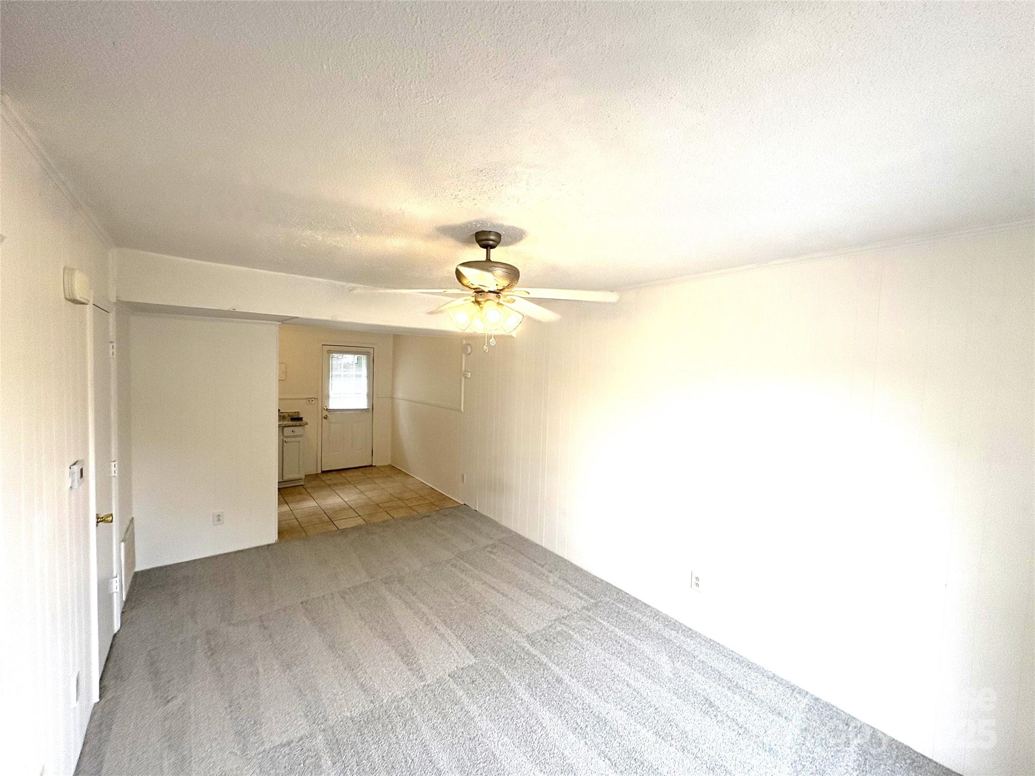 108 Durham Road Stanley, NC 28164 - Photo 6 of 20 a view of a room with a ceiling fan and a window