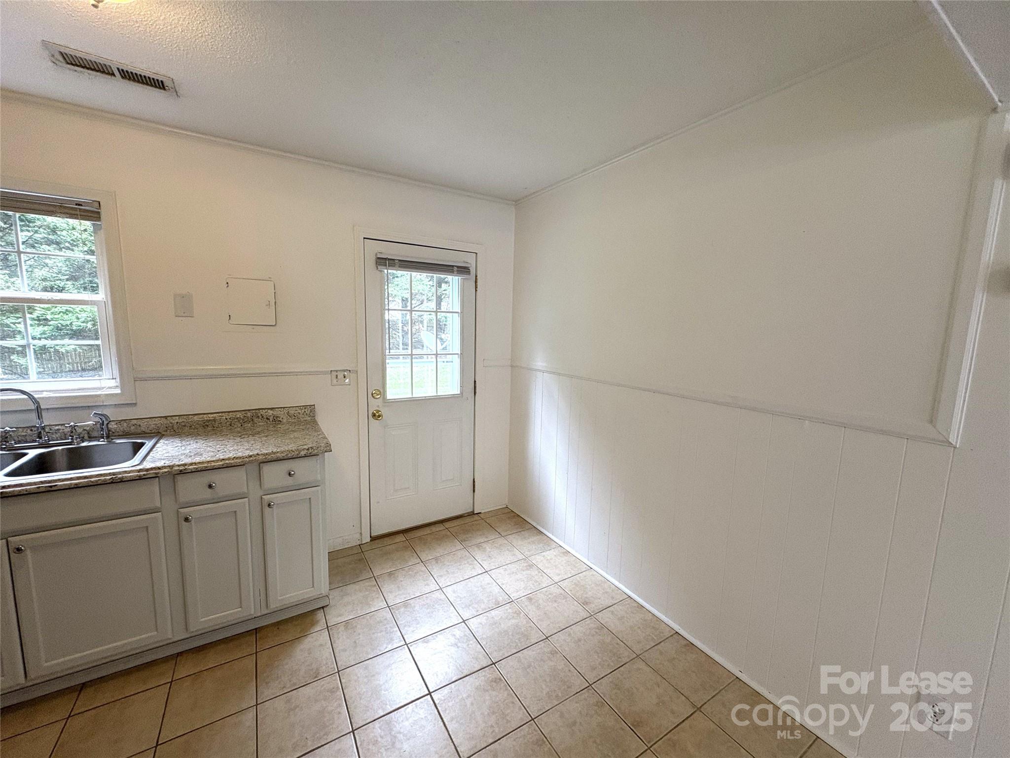 108 Durham Road Stanley, NC 28164 - Photo 7 of 20 a view of a kitchen with dishwasher and white cabinets