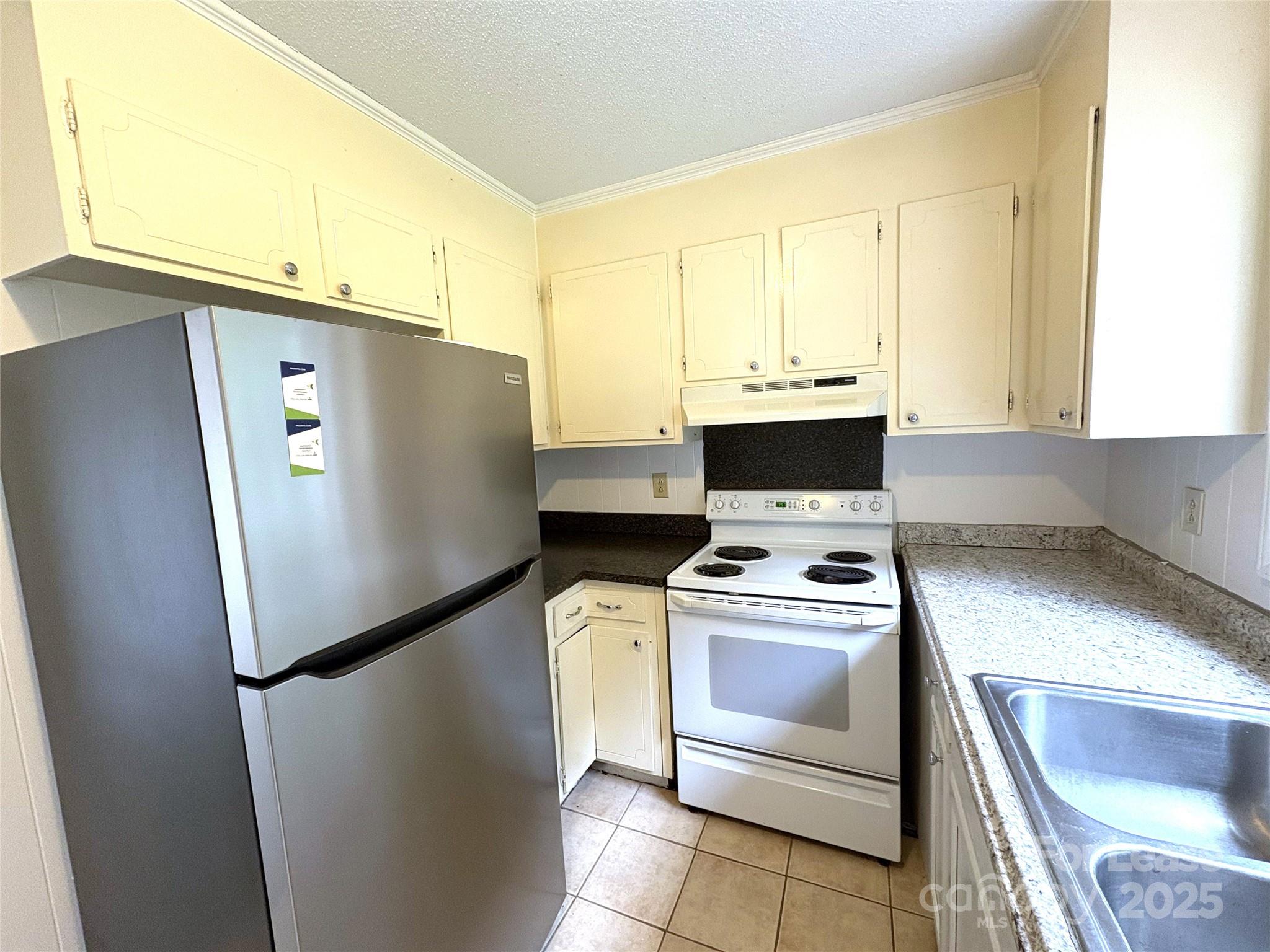 108 Durham Road Stanley, NC 28164 - Photo 10 of 20 a white refrigerator freezer and a stove sitting inside of a kitchen