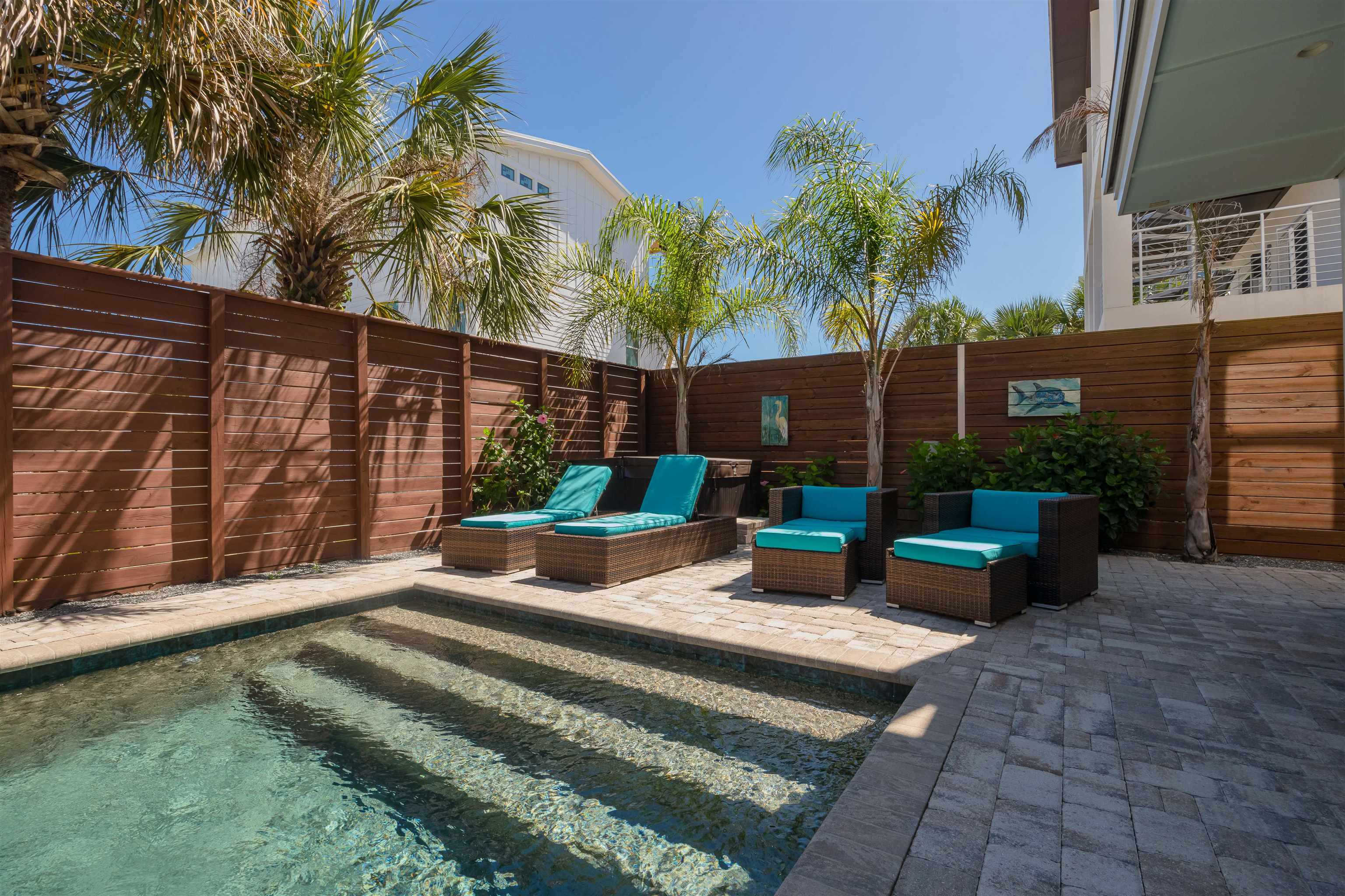 10 5th Street St. Augustine Beach, FL 32080 - Photo 11 of 49 a view of a patio with couches table and chairs and potted plants