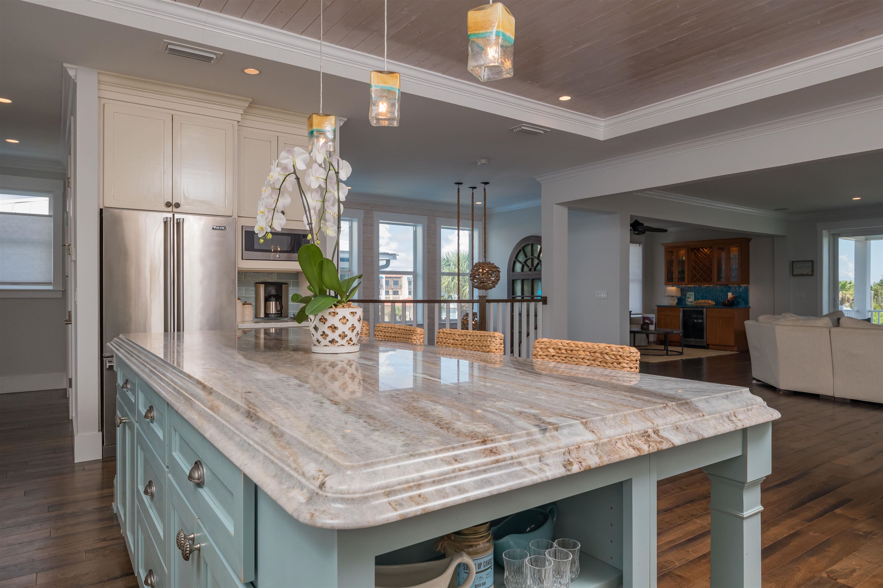 10 5th Street St. Augustine Beach, FL 32080 - Photo 20 of 49 a kitchen with stainless steel appliances granite countertop a kitchen island a stove a refrigerator a kitchen island a sink cabinets and wooden floor