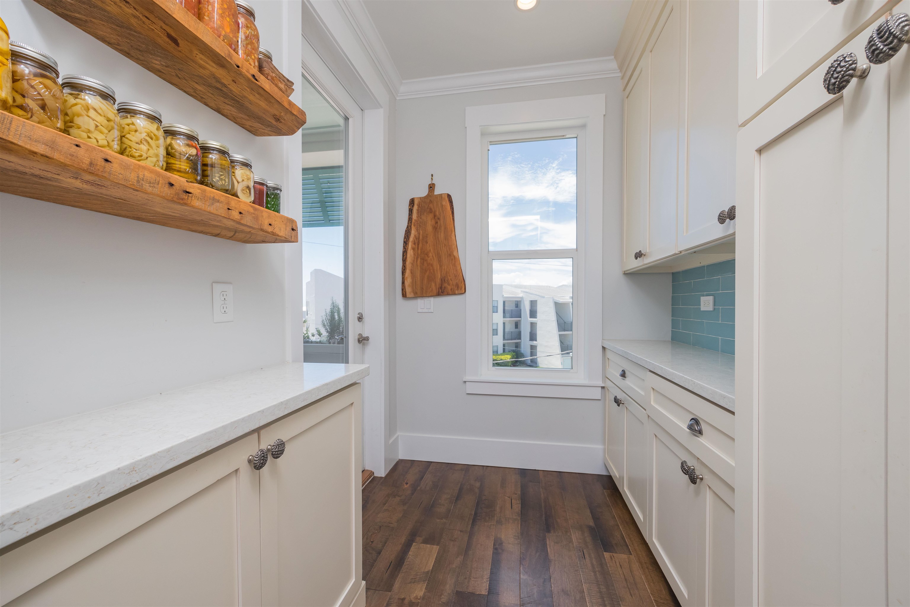 10 5th Street St. Augustine Beach, FL 32080 - Photo 24 of 49 a kitchen with white cabinets and wooden floor