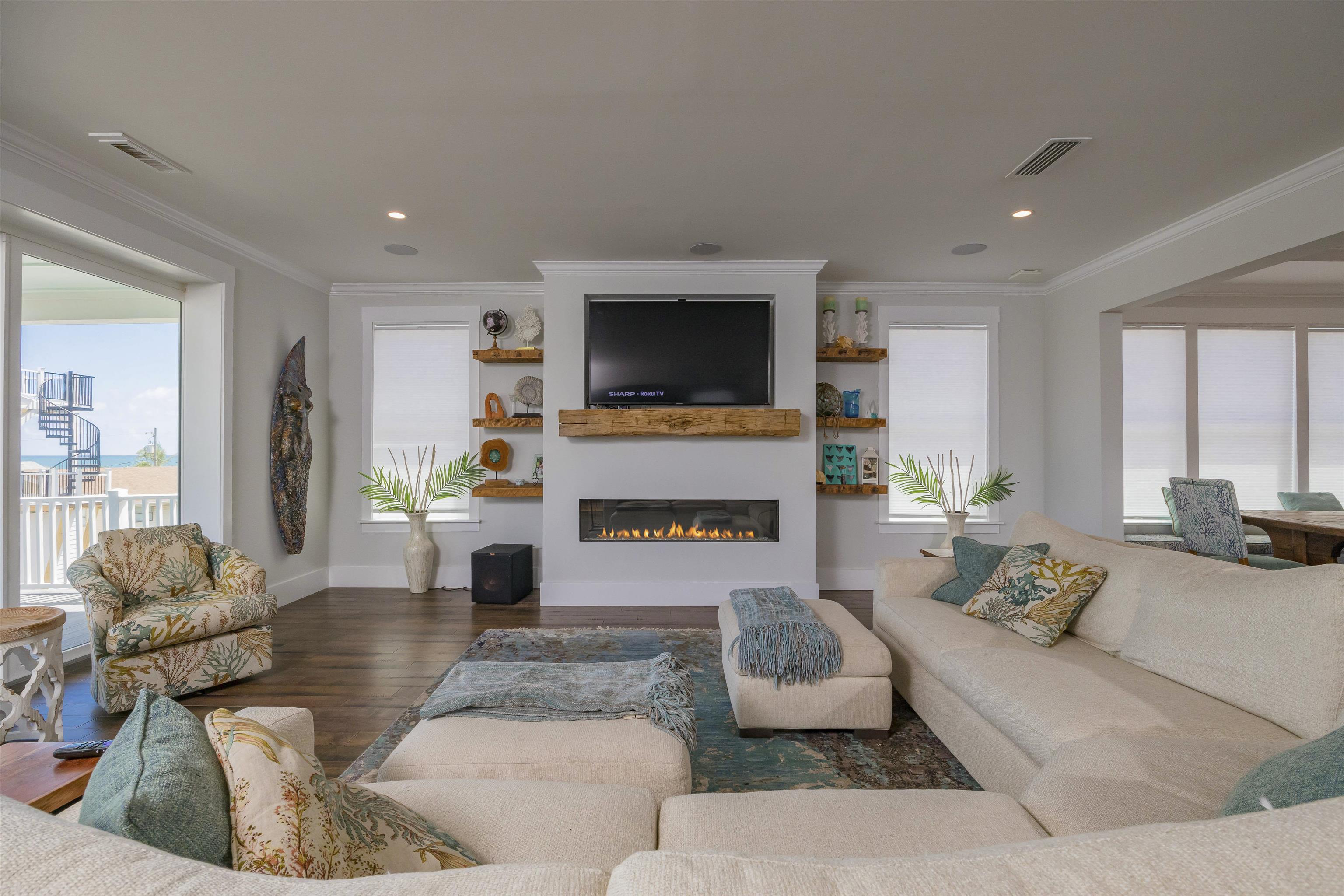 10 5th Street St. Augustine Beach, FL 32080 - Photo 4 of 49 a living room with furniture a fireplace and a flat screen tv