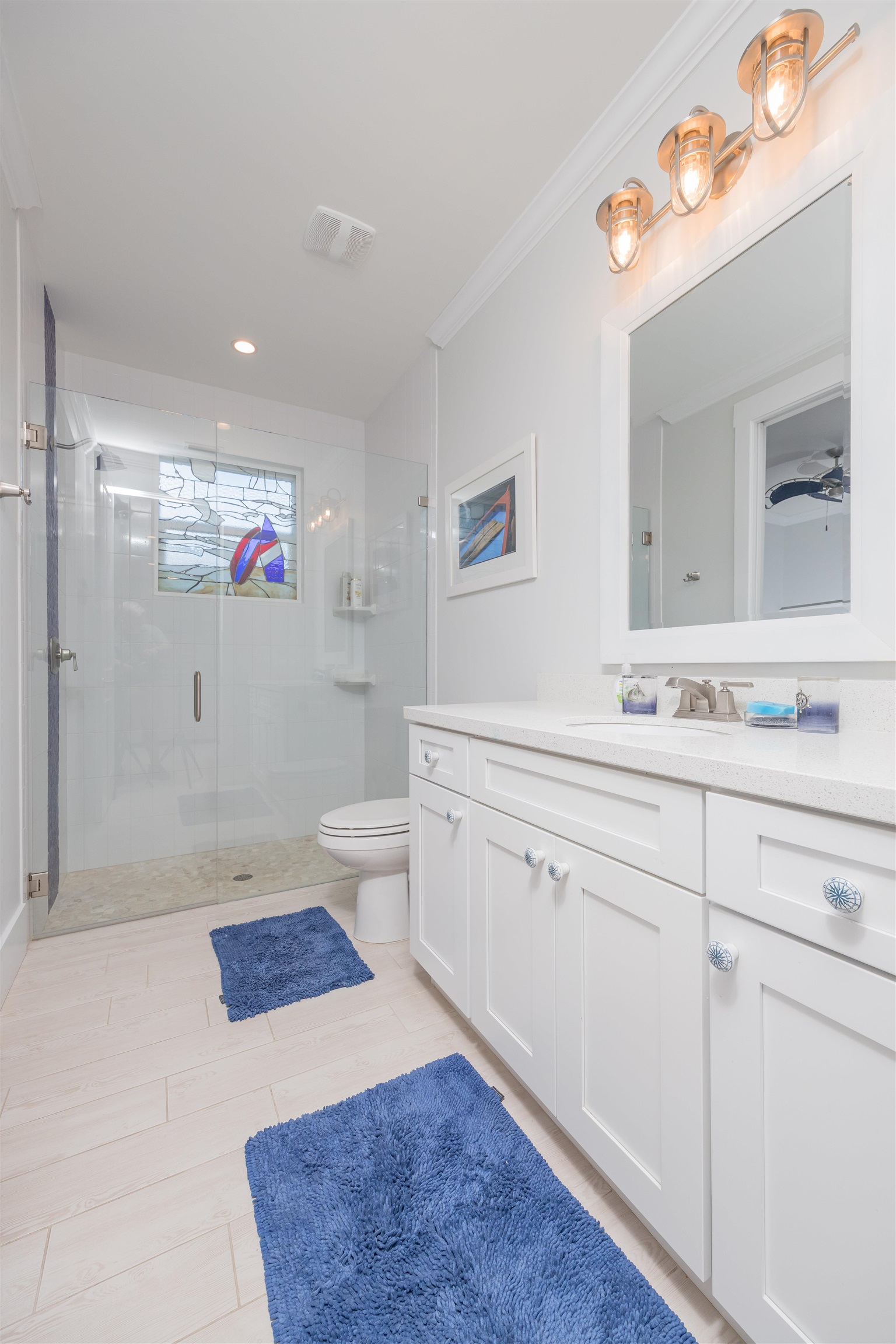 10 5th Street St. Augustine Beach, FL 32080 - Photo 43 of 49 a spacious bathroom with a sink a toilet a mirror and shower