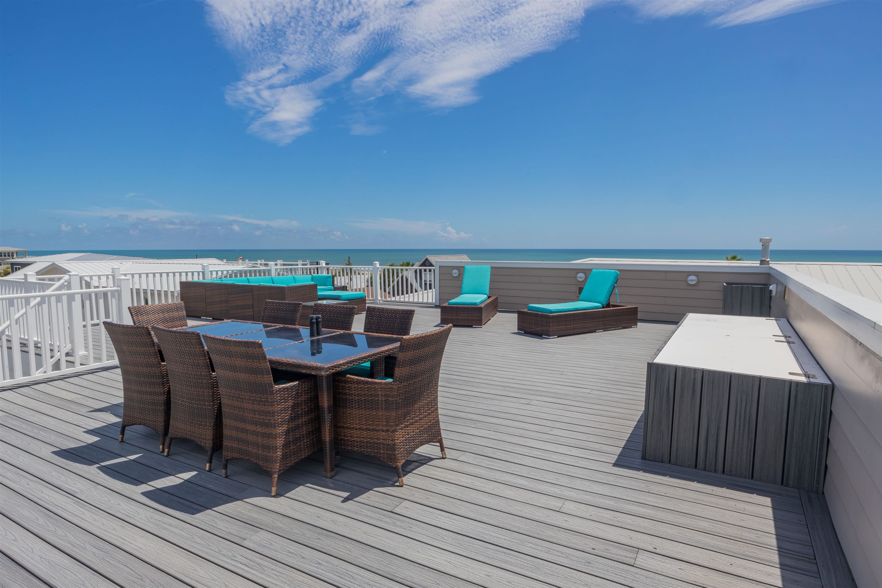 10 5th Street St. Augustine Beach, FL 32080 - Photo 6 of 49 a view of a roof deck with table and chairs