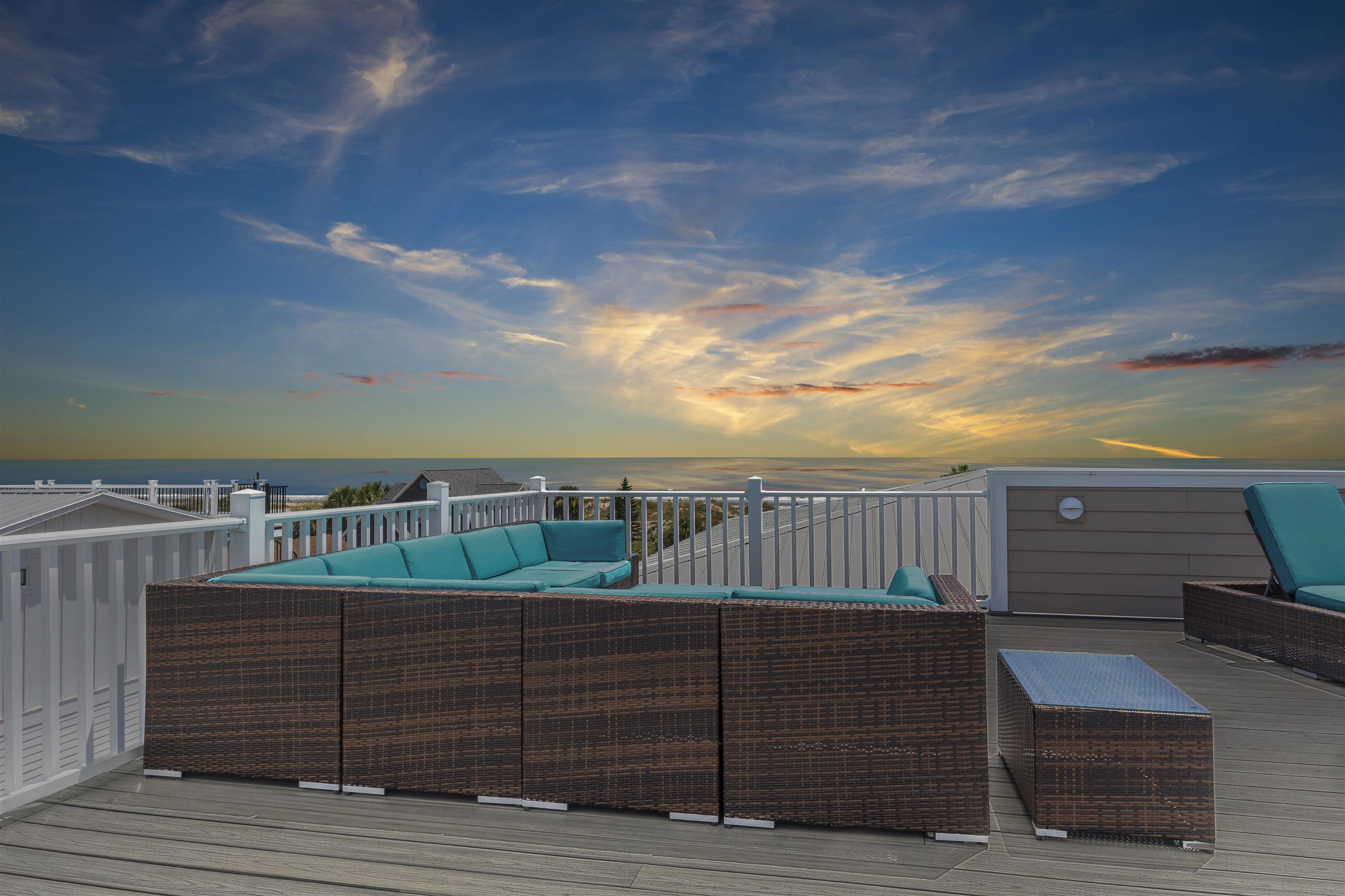 10 5th Street St. Augustine Beach, FL 32080 - Photo 8 of 49 a view of roof deck with two chairs and wooden fence