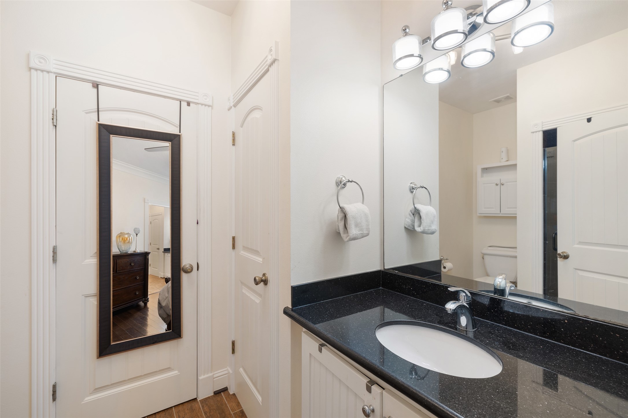 608 Jewett Street Houston, TX 77009 - Photo 17 of 23 a bathroom with a granite countertop sink a mirror and a shower
