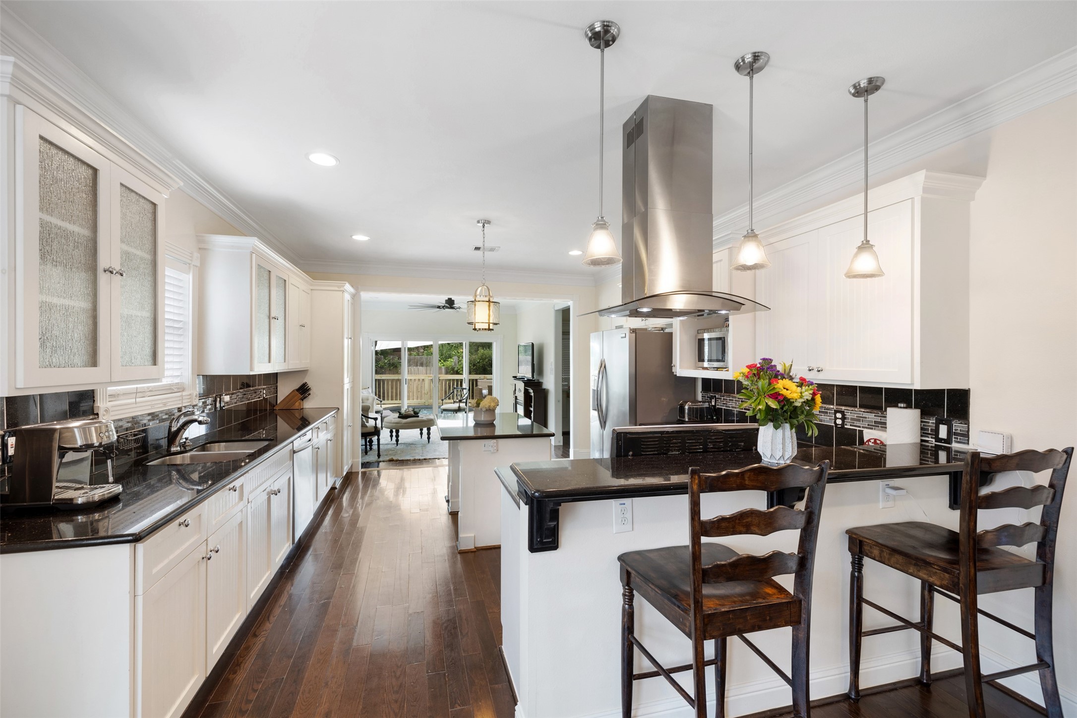 608 Jewett Street Houston, TX 77009 - Photo 7 of 23 a kitchen with stainless steel appliances kitchen island granite countertop a stove top oven a sink a dining table and chairs with wooden floor