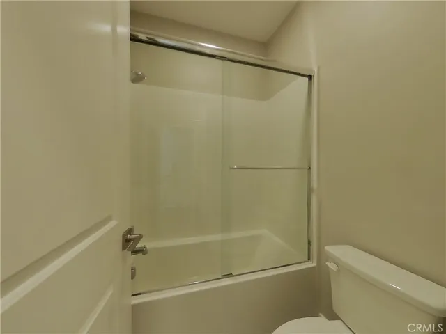a bathroom with a shower and a toilet