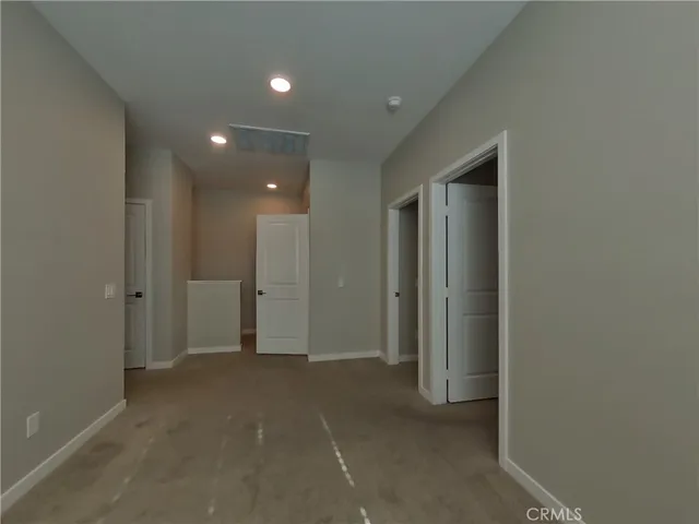 an empty room with closet and a bathroom