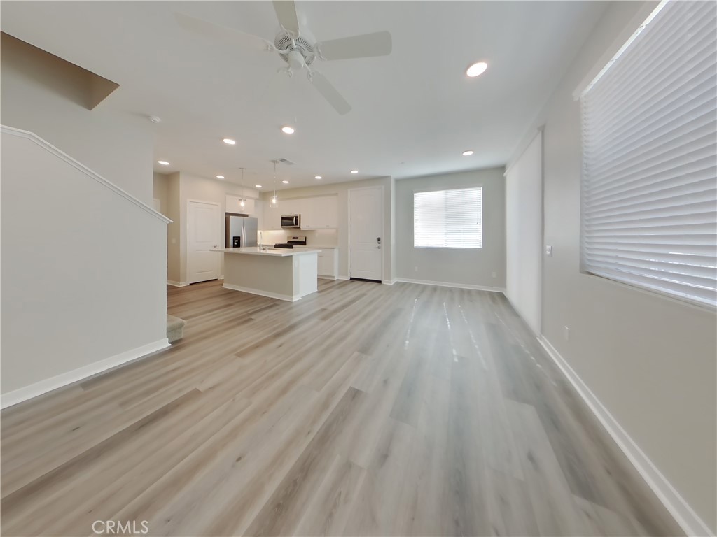 36591 Pepino Court Wildomar, CA 92595 - Photo 2 of 29 an empty room with wooden floor and windows