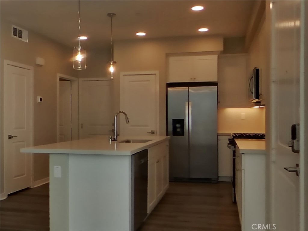 36591 Pepino Court Wildomar, CA 92595 - Photo 5 of 29 a kitchen with kitchen island a sink stainless steel appliances and cabinets