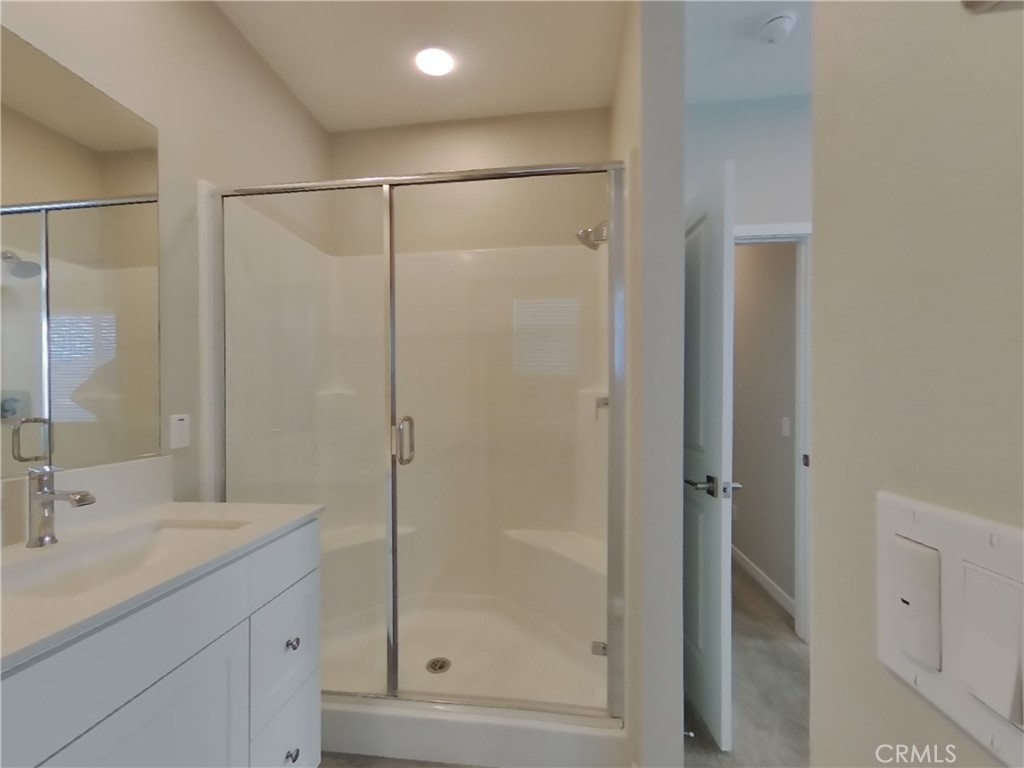 36591 Pepino Court Wildomar, CA 92595 - Photo 8 of 29 a bathroom with a shower sink and mirror
