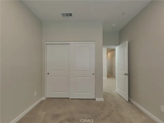 an empty room with closet area