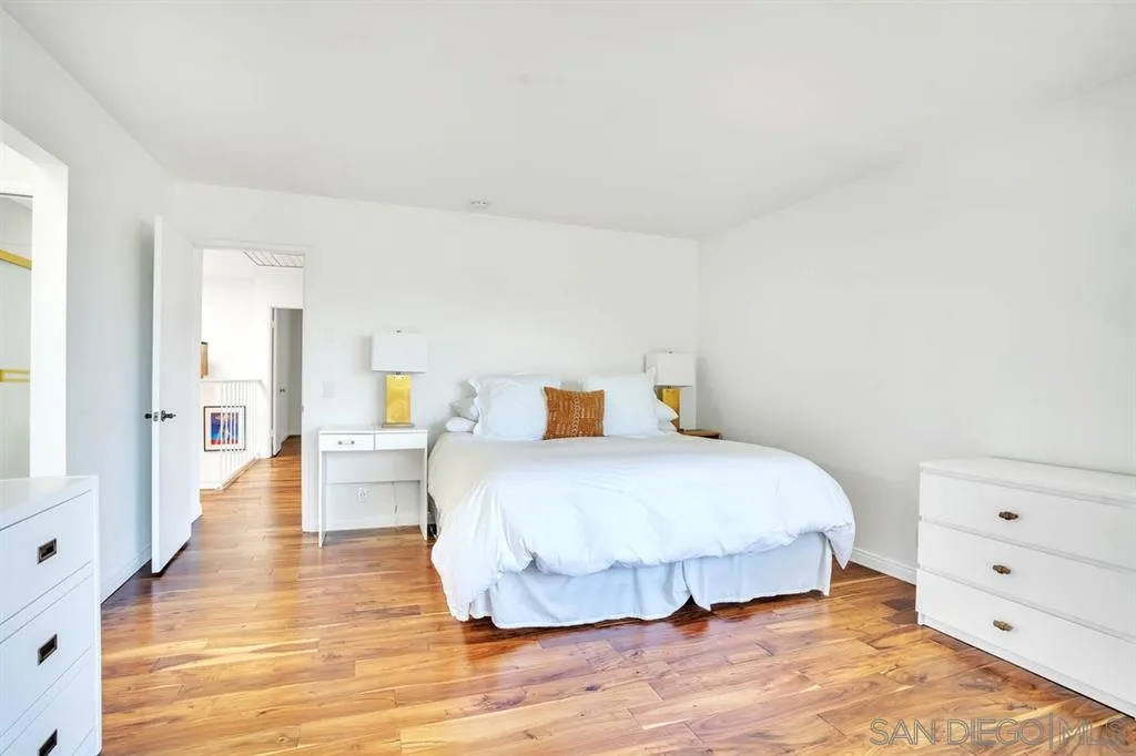 3047 Via De Caballo Encinitas, CA 92024 - Photo 15 of 25 a bedroom with a bed and wooden floor