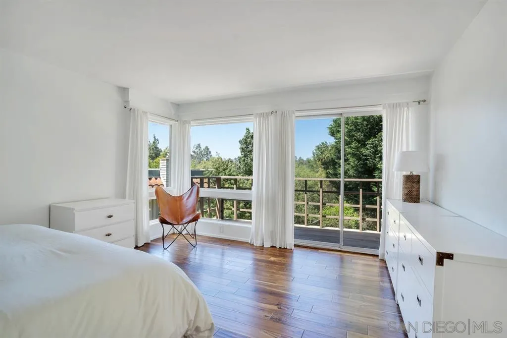 3047 Via De Caballo Encinitas, CA 92024 - Photo 16 of 25 a bedroom with a bed and wooden floor