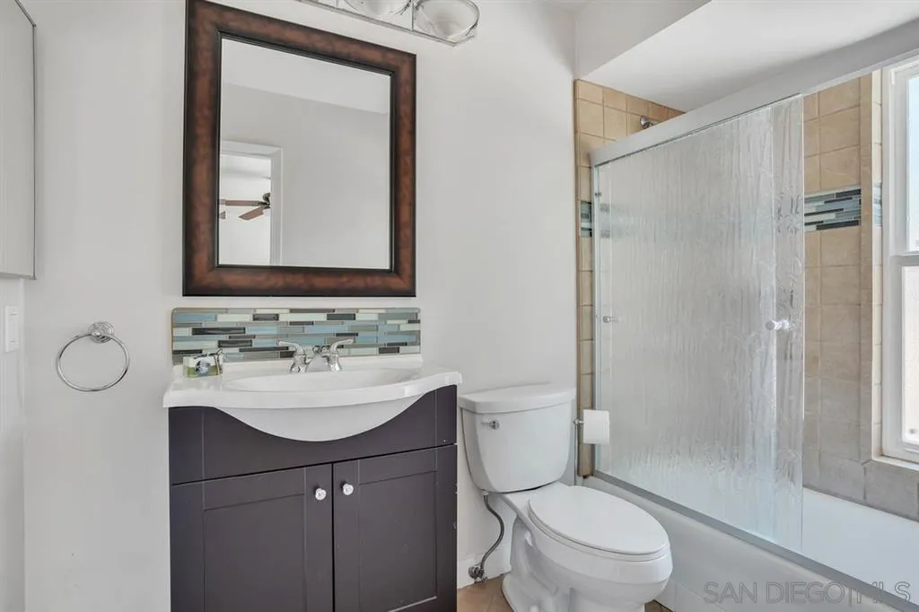 3047 Via De Caballo Encinitas, CA 92024 - Photo 21 of 25 a bathroom with a sink toilet mirror and shower
