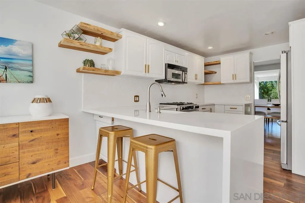 3047 Via De Caballo Encinitas, CA 92024 - Photo 5 of 25 a kitchen with stainless steel appliances granite countertop a refrigerator and a stove top oven