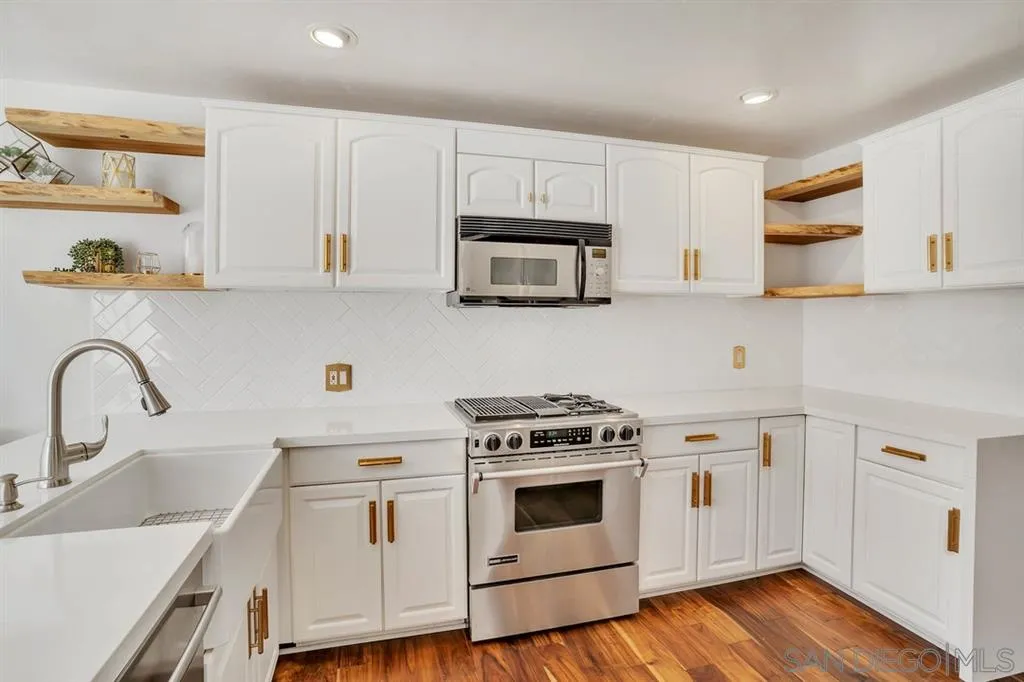 3047 Via De Caballo Encinitas, CA 92024 - Photo 6 of 25 a kitchen with granite countertop white cabinets and white appliances