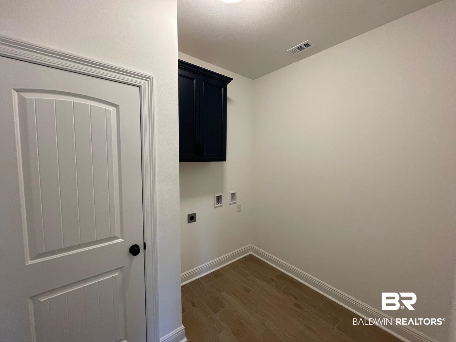 1396 Fenton Circle Foley, AL 36535 - Photo 11 of 14 Washroom with washer hookup, cabinets, dark hardwood / wood-style floors, and electric dryer hookup