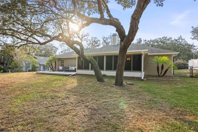 an aerial view of residential houses with outdoor space and trees