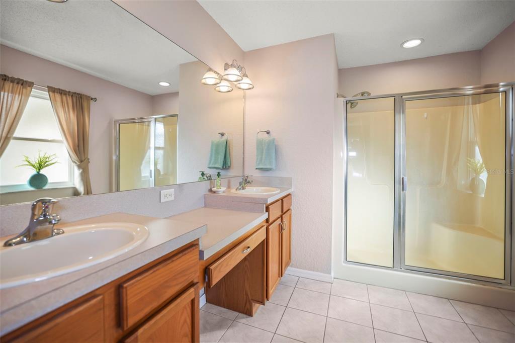 8412 Christopher Lane Weeki Wachee, FL 34613 - Photo 22 of 43 a bathroom with a double vanity sink mirror and shower