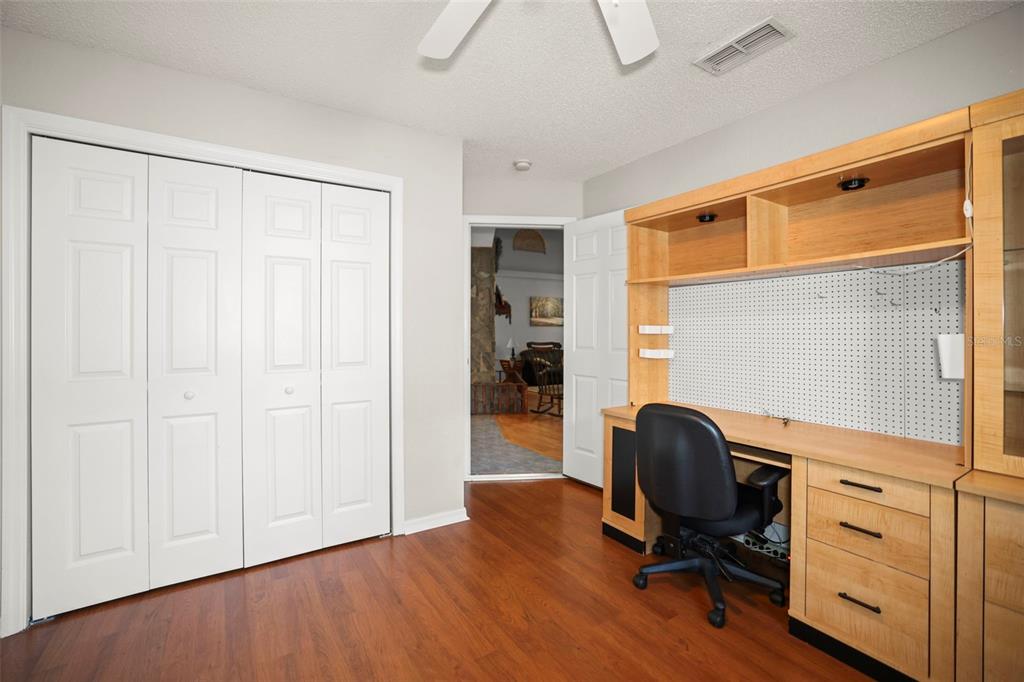 8412 Christopher Lane Weeki Wachee, FL 34613 - Photo 27 of 39 a view of workspace with wooden floor chair and windows