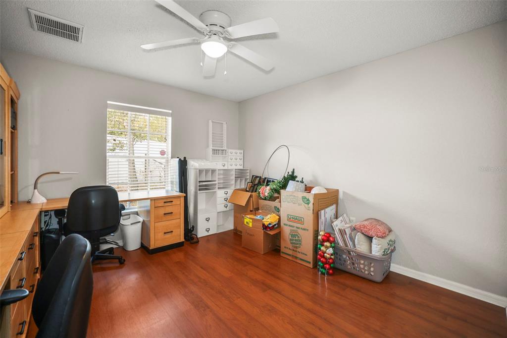 8412 Christopher Lane Weeki Wachee, FL 34613 - Photo 28 of 43 a room with furniture and wooden floor