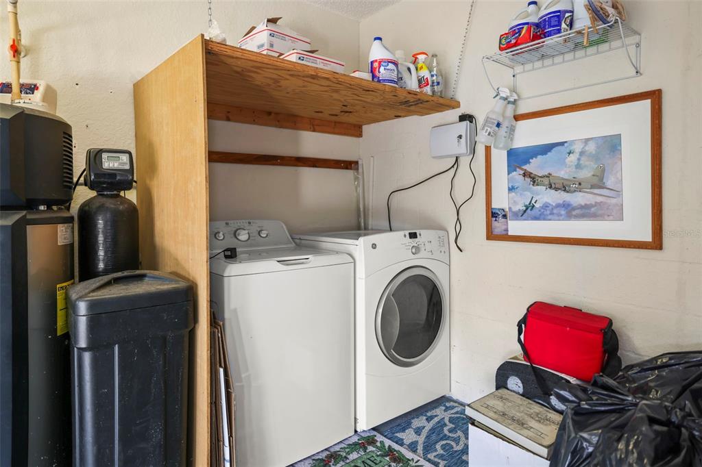 8412 Christopher Lane Weeki Wachee, FL 34613 - Photo 38 of 43 a utility room with dryer washer and a flat screen tv