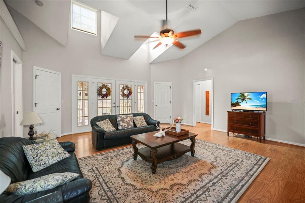 8412 Christopher Lane Weeki Wachee, FL 34613 - Photo 5 of 43 a living room with furniture a rug and a chandelier