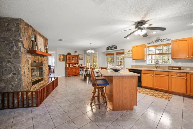 a dining room with furniture a chandelier and wooden floor