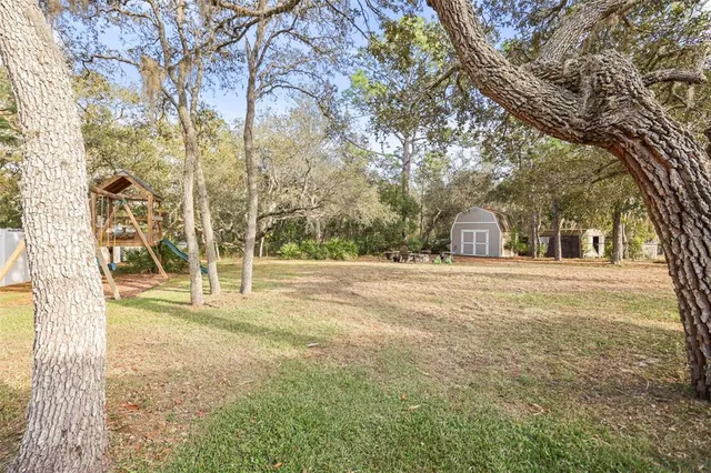 a view of a backyard with sitting area