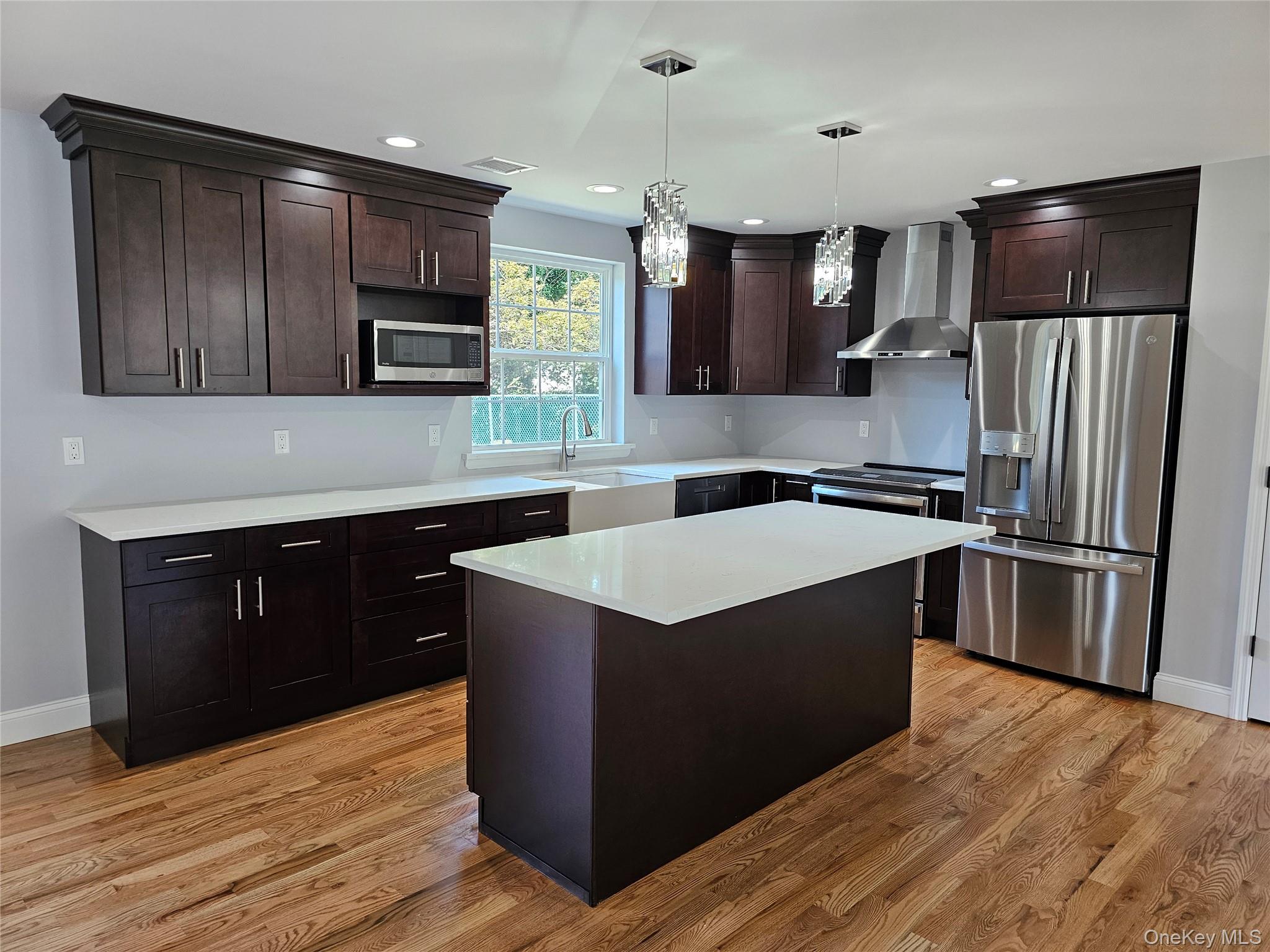 13 North Swezeytown Road Middle Island, NY 11953 - Photo 4 of 9 a kitchen with a cabinets counter top space stainless steel appliances and cabinets