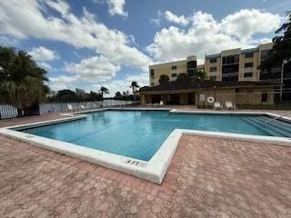 a view of swimming pool is middle in the garden