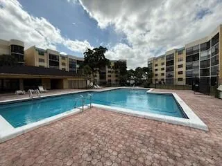 a view of a swimming pool with outdoor seating