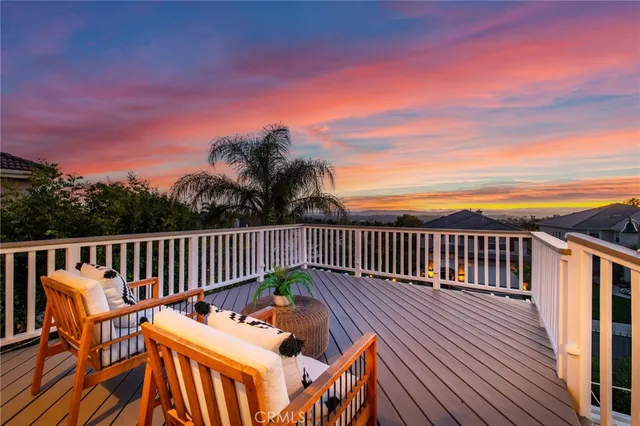 a roof deck with wooden floor and fence