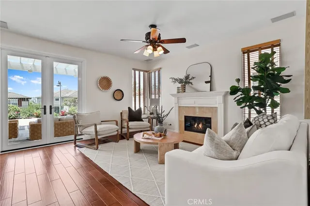 a living room with furniture kitchen view and a large window