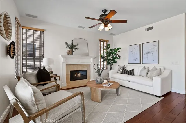 a living room with furniture kitchen view and a potted plant
