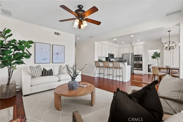 a kitchen with stainless steel appliances granite countertop a refrigerator and a table