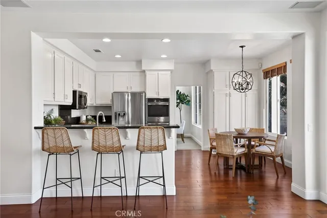a kitchen with stainless steel appliances granite countertop a refrigerator and a stove top oven