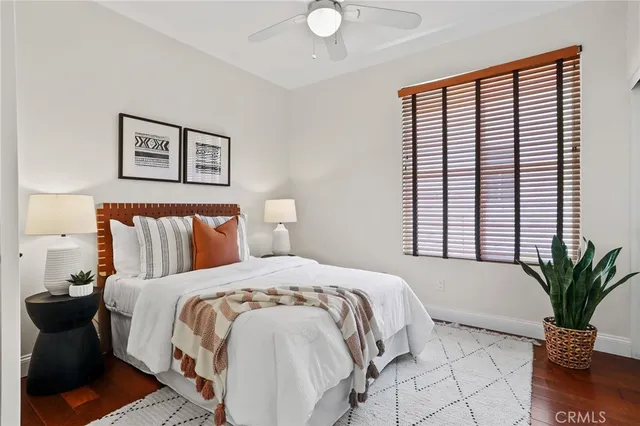 a spacious bedroom with a bed and a chandelier