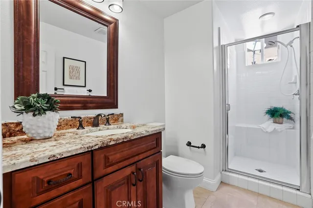 a bedroom with a bed a table and flat screen tv