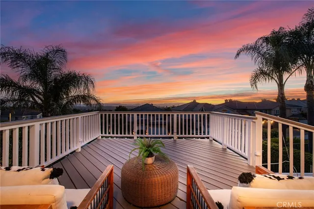 a view of a house with a yard and potted plants