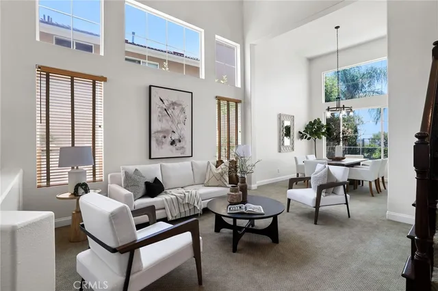 a living room with furniture a large window and a table